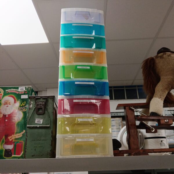 Stack of nine plastic craft drawers for organization.