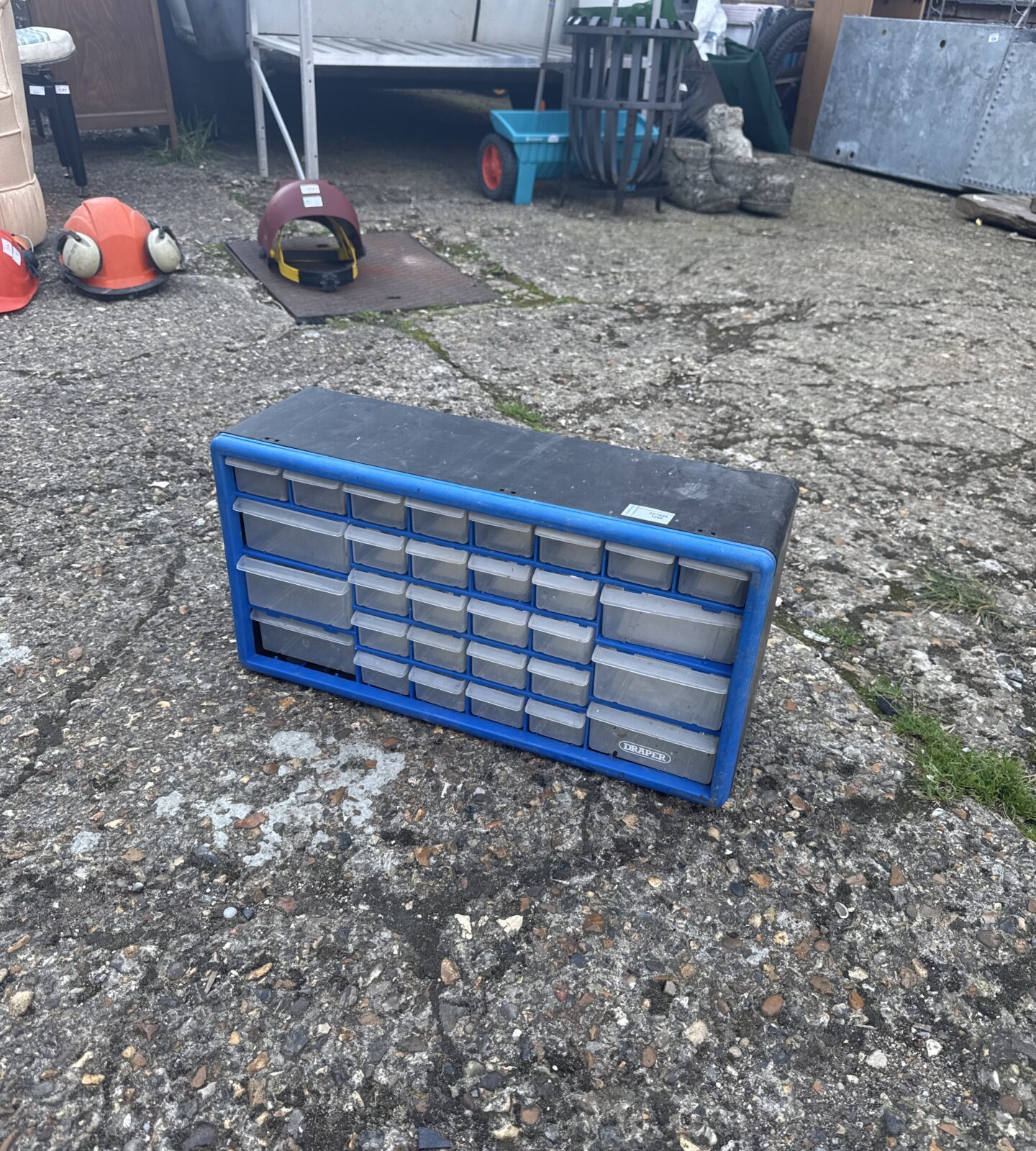 Blue plastic drawer cabinet for tool and parts storage.