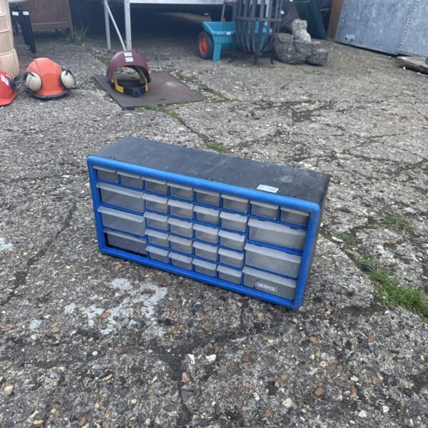 Blue plastic drawer cabinet for tool and parts storage.