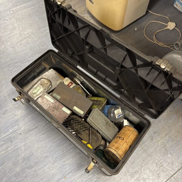 Open plastic toolbox filled with assorted tools and automotive parts.