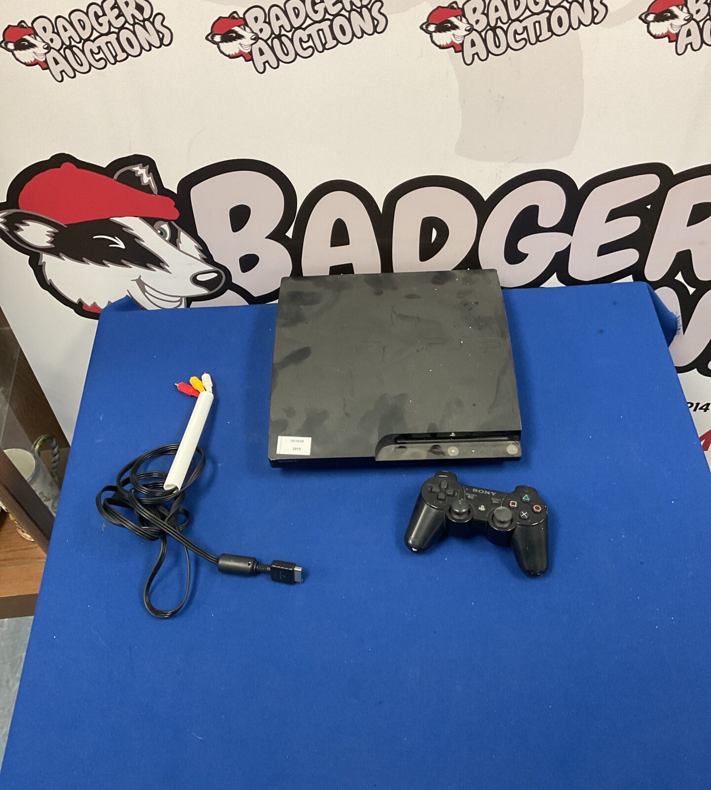 Black Playstation 3 console with remote control for gaming.