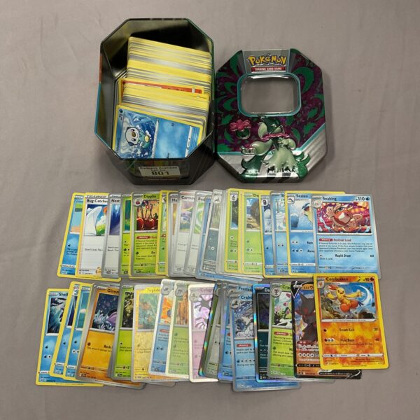 Pokemon card collection in a decorative tin with holo cards.
