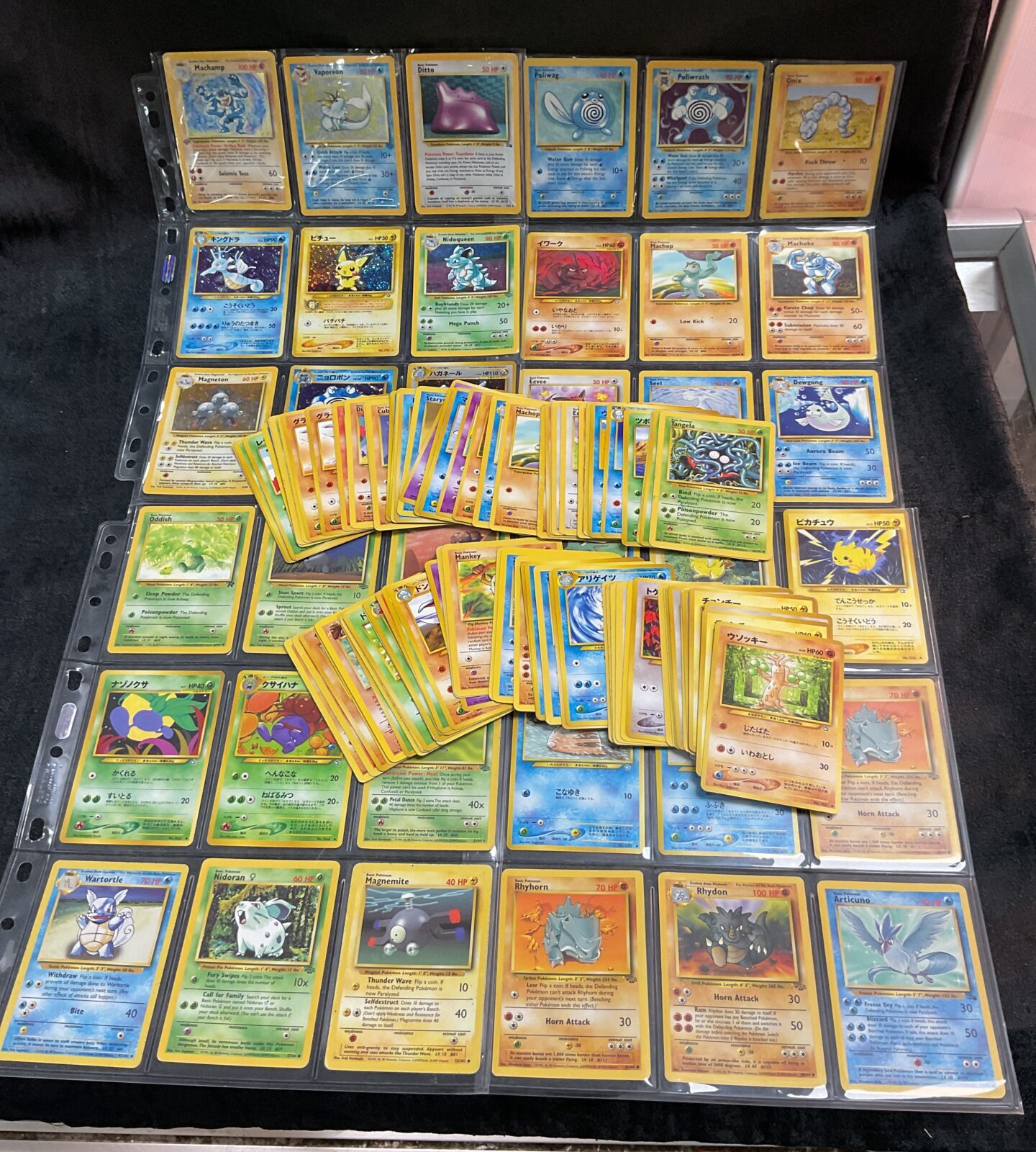 Large lot of Pokemon cards in a protective binder.