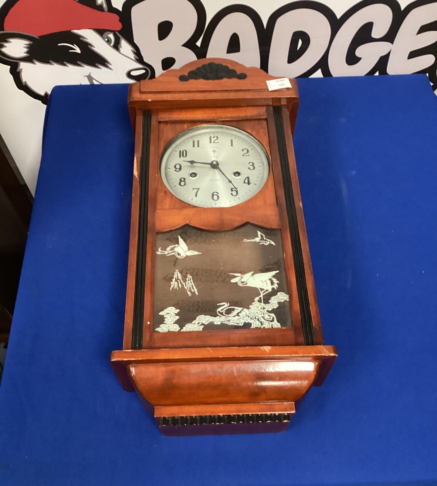 Vintage Polaris wall clock with pendulum and key, antique home decor.