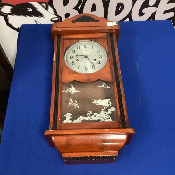 Vintage Polaris wall clock with pendulum and key, antique home decor.