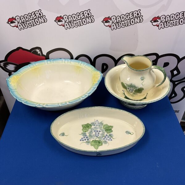 Antique Poole Pottery wash bowl and jug set with floral design.