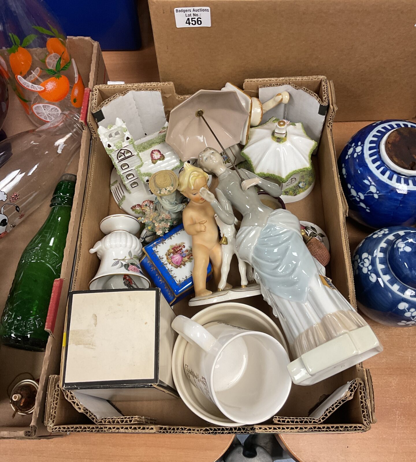Tray of vintage porcelain figurines including Nao and cherub.