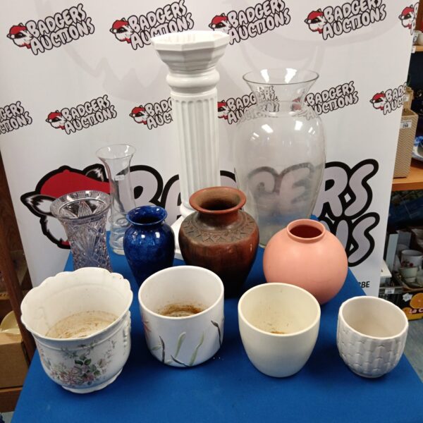 Collection of colourful porcelain plant pots and glass vases.