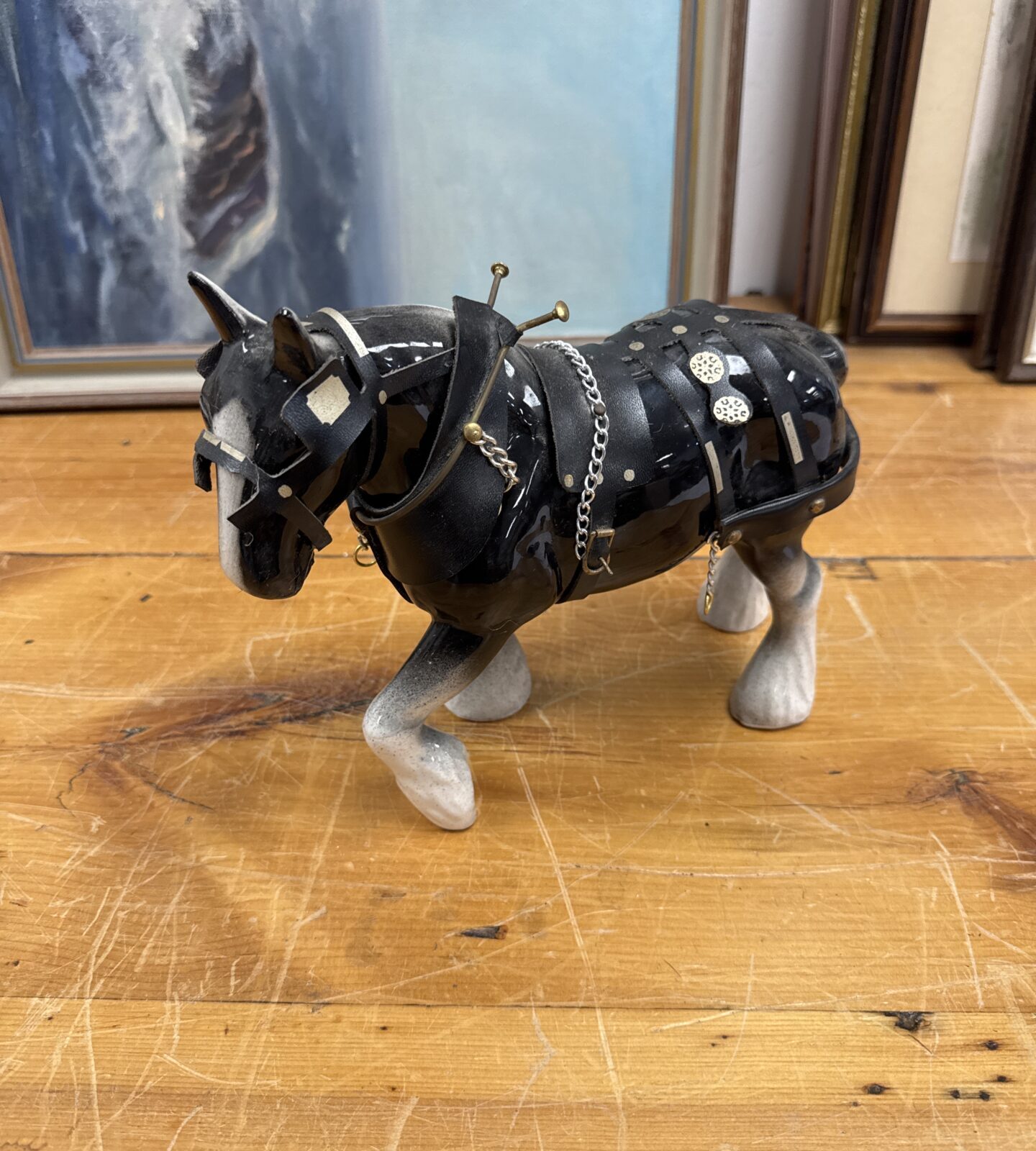 Detailed porcelain shire horse ornament with harness.