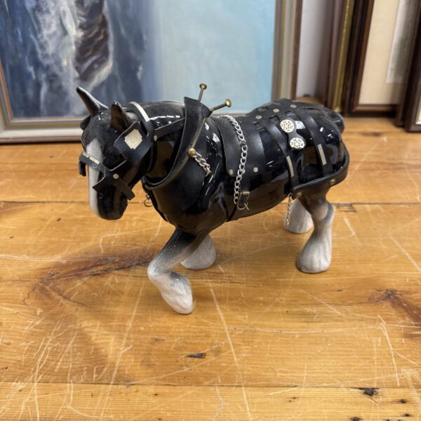Detailed porcelain shire horse ornament with harness.