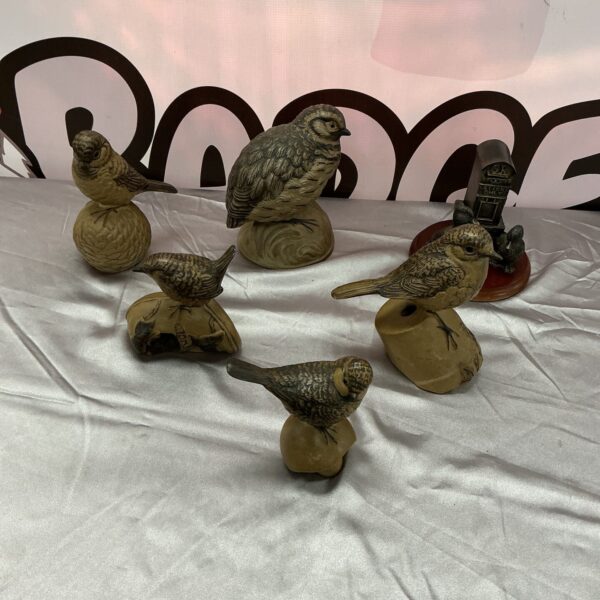 Six vintage pottery bird figurines displayed as a collection.