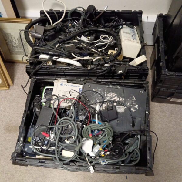 Mixed lot of power supplies and cables for electronics projects.