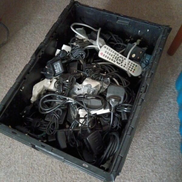 Mixed lot of power supplies and cables for electronics projects.
