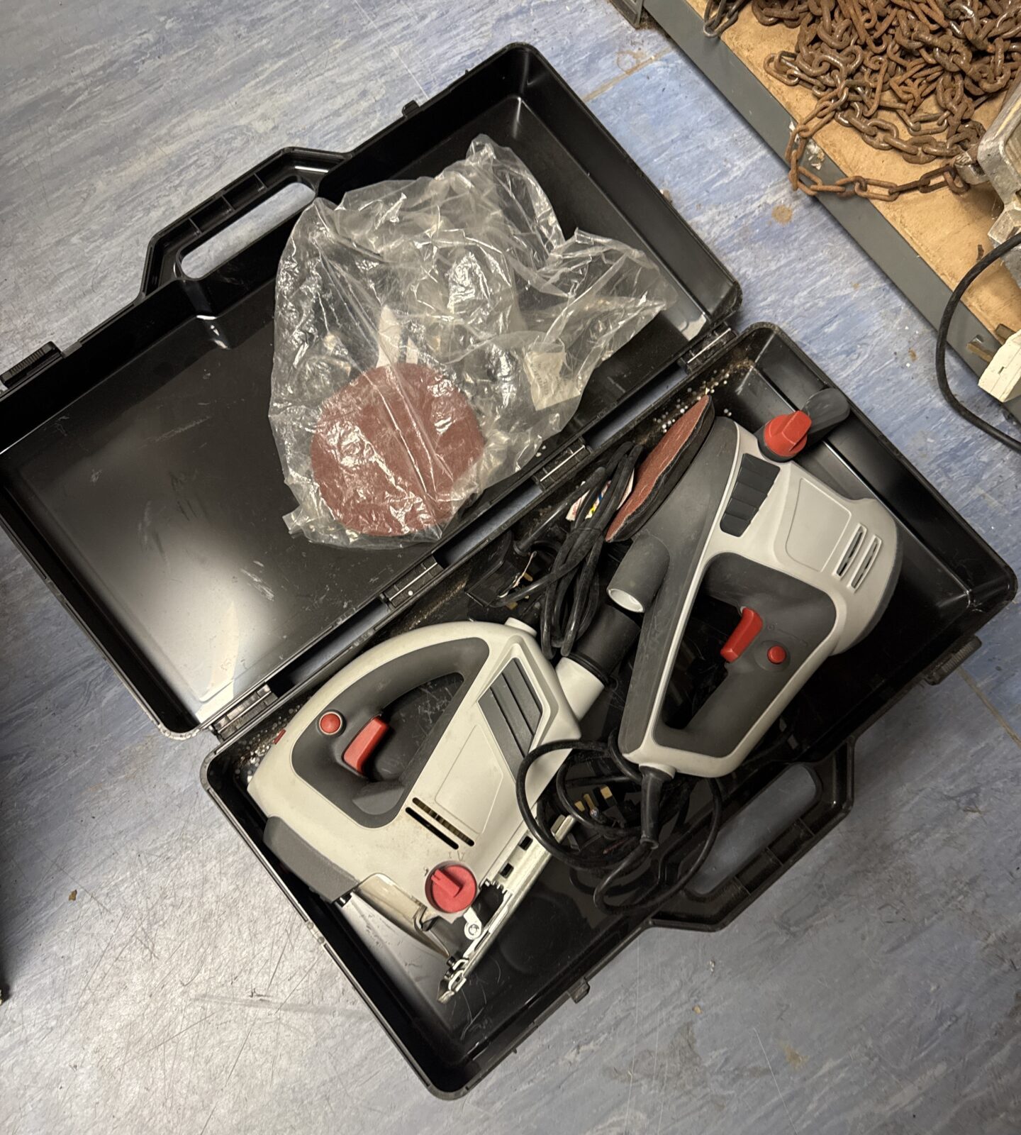 Closed power tool set case with tools inside.