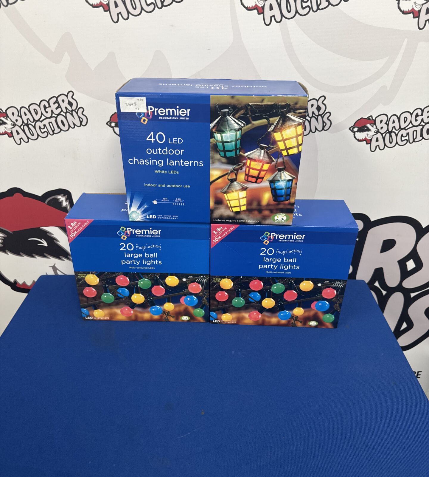 Three boxes of Premier Decorations chasing lantern lights in original packaging.