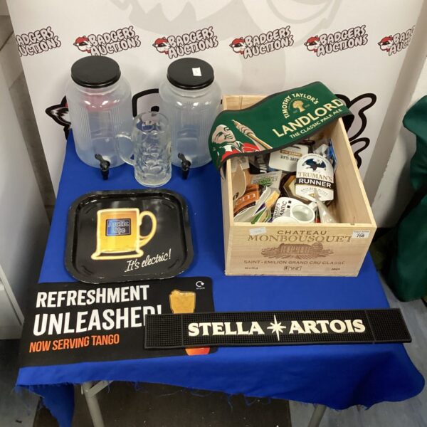 Pub memorabilia lot featuring Stella Artois items and vintage signage.