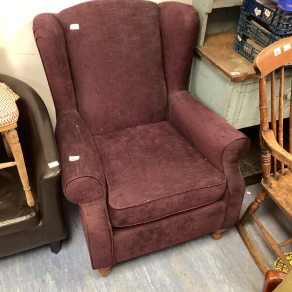 Purple wingback chair with velvet upholstery, vintage style.