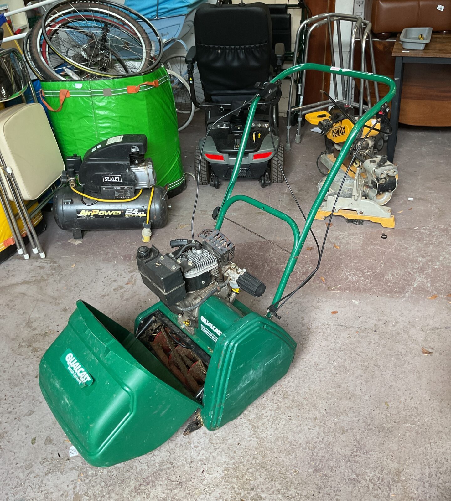 Vintage Qualcast Bosch classic petrol mower in used condition.