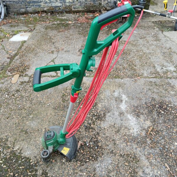 Used Qualcast electric grass strimmer for garden maintenance.