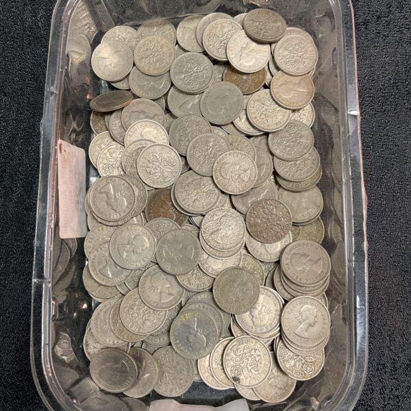 A large quantity of silver British sixpence coins in a plastic container.