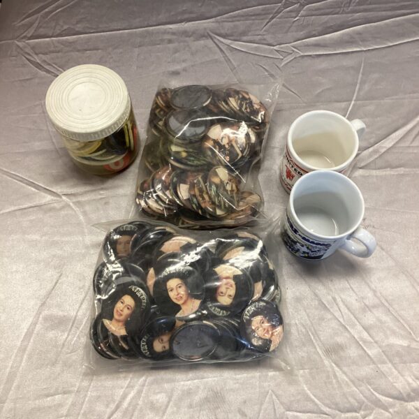 Queen Elizabeth badges and football mugs in a collectables lot.