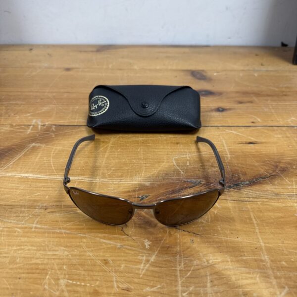 Vintage Ray Ban aviator sunglasses with gunmetal frame and brown lenses.