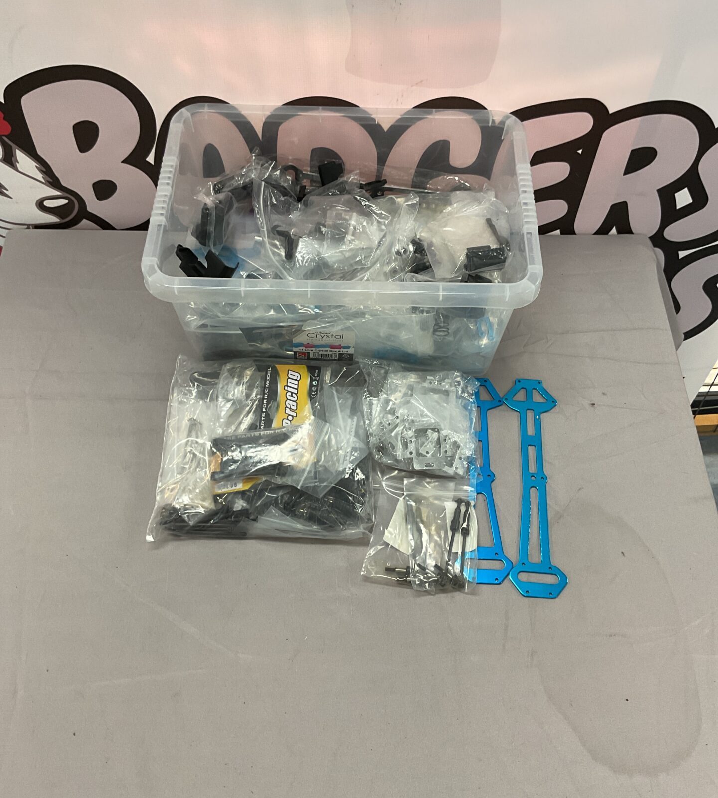 RC car parts lot with various components for repairs and upgrades.