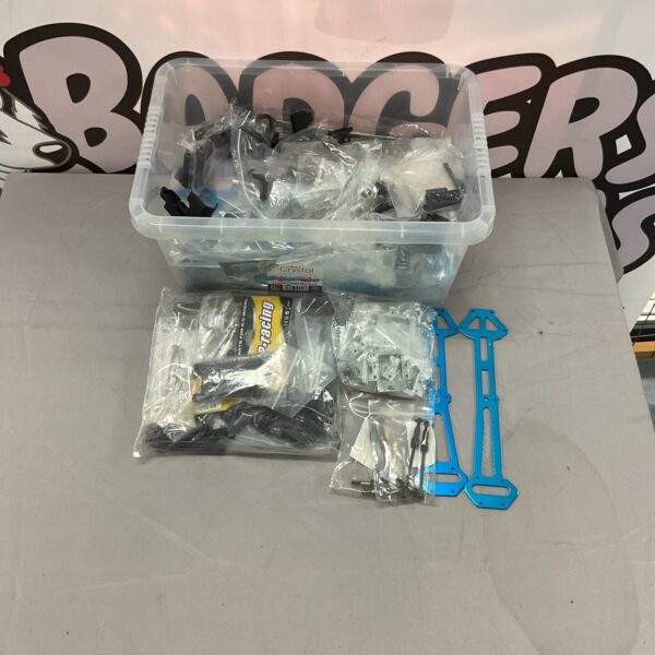 RC car parts lot with various components for repairs and upgrades.