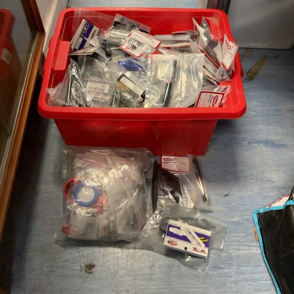 Assorted RC model parts in a plastic storage bin.