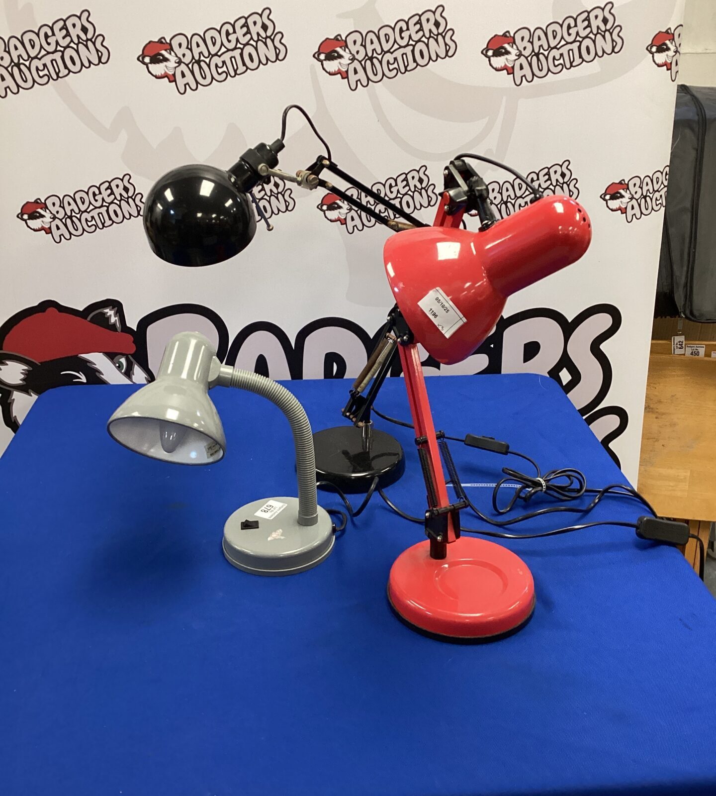 Vintage red Anglepoise lamp on a table.