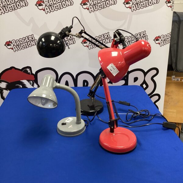 Vintage red Anglepoise lamp on a table.