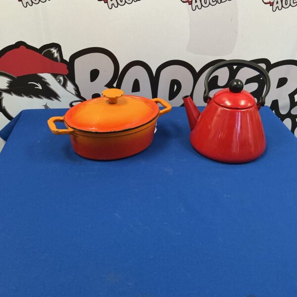Vintage red cast iron casserole dish and metal kettle set.