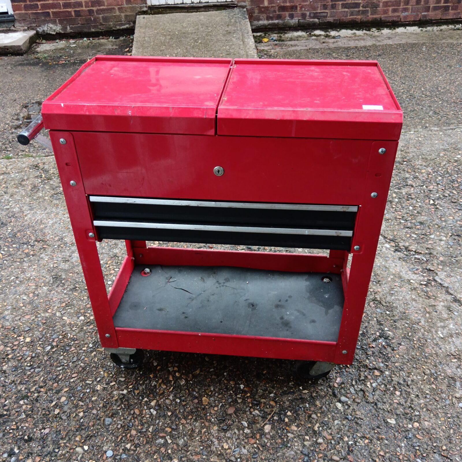 Red mechanics tool cabinet on wheels for workshop storage.