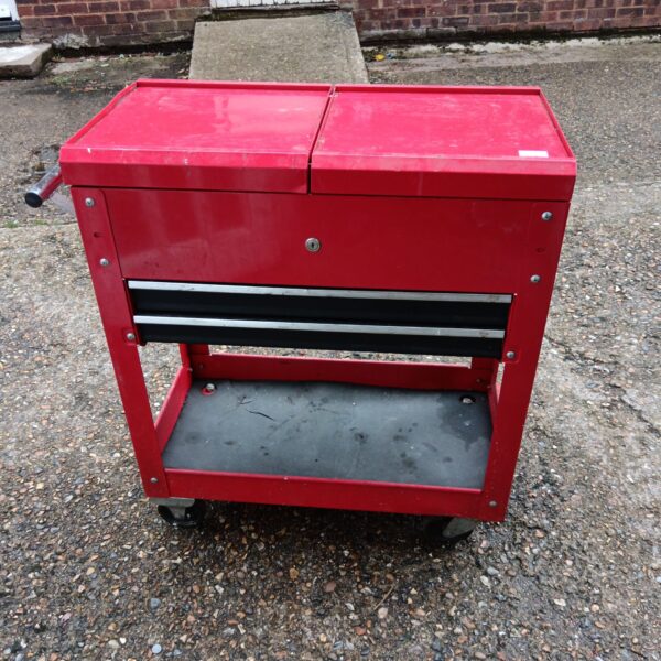 Red mechanics tool cabinet on wheels for workshop storage.