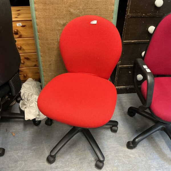 Side view of a red office chair with a swivel base.