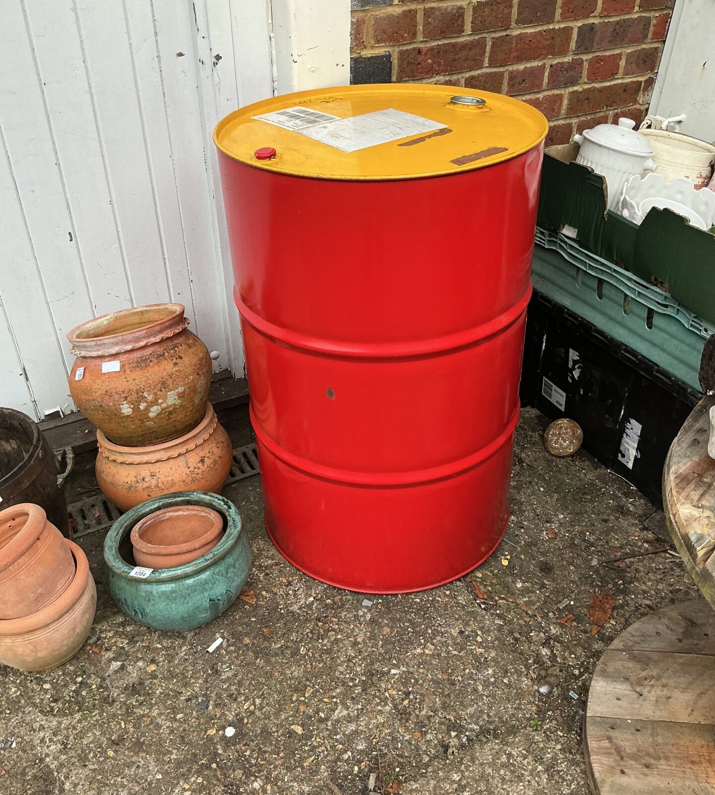 Red oil drum, a vintage industrial storage container.