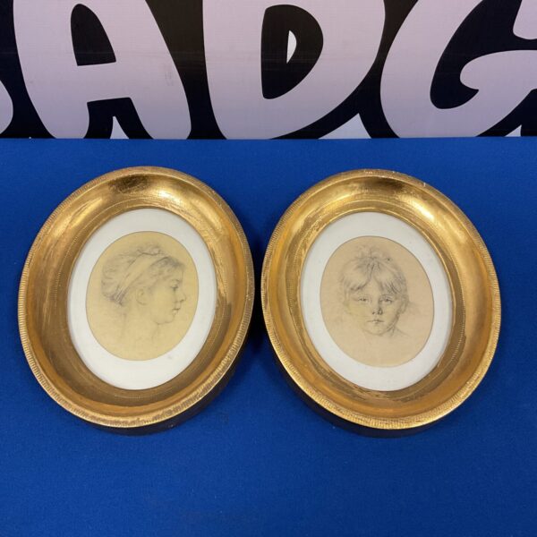 Antique pair of silk portraits by Rene David in gilt frames.