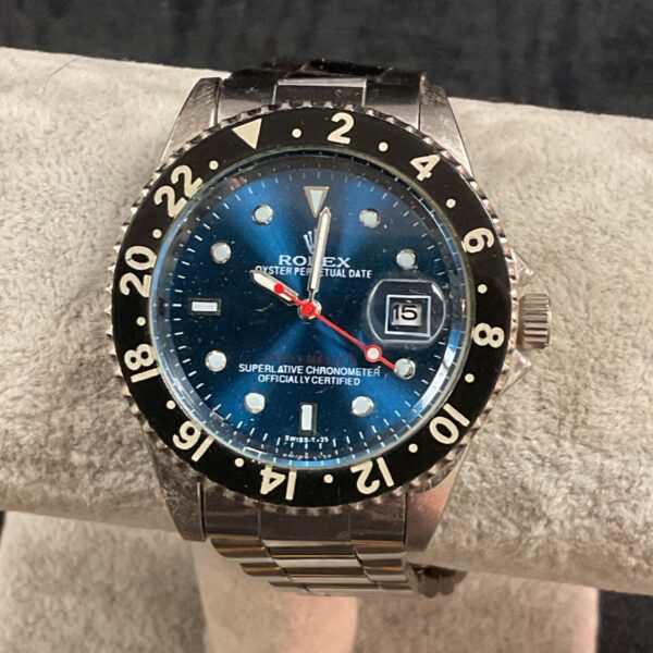 Black dial replica quartz wristwatch with stainless steel bracelet.