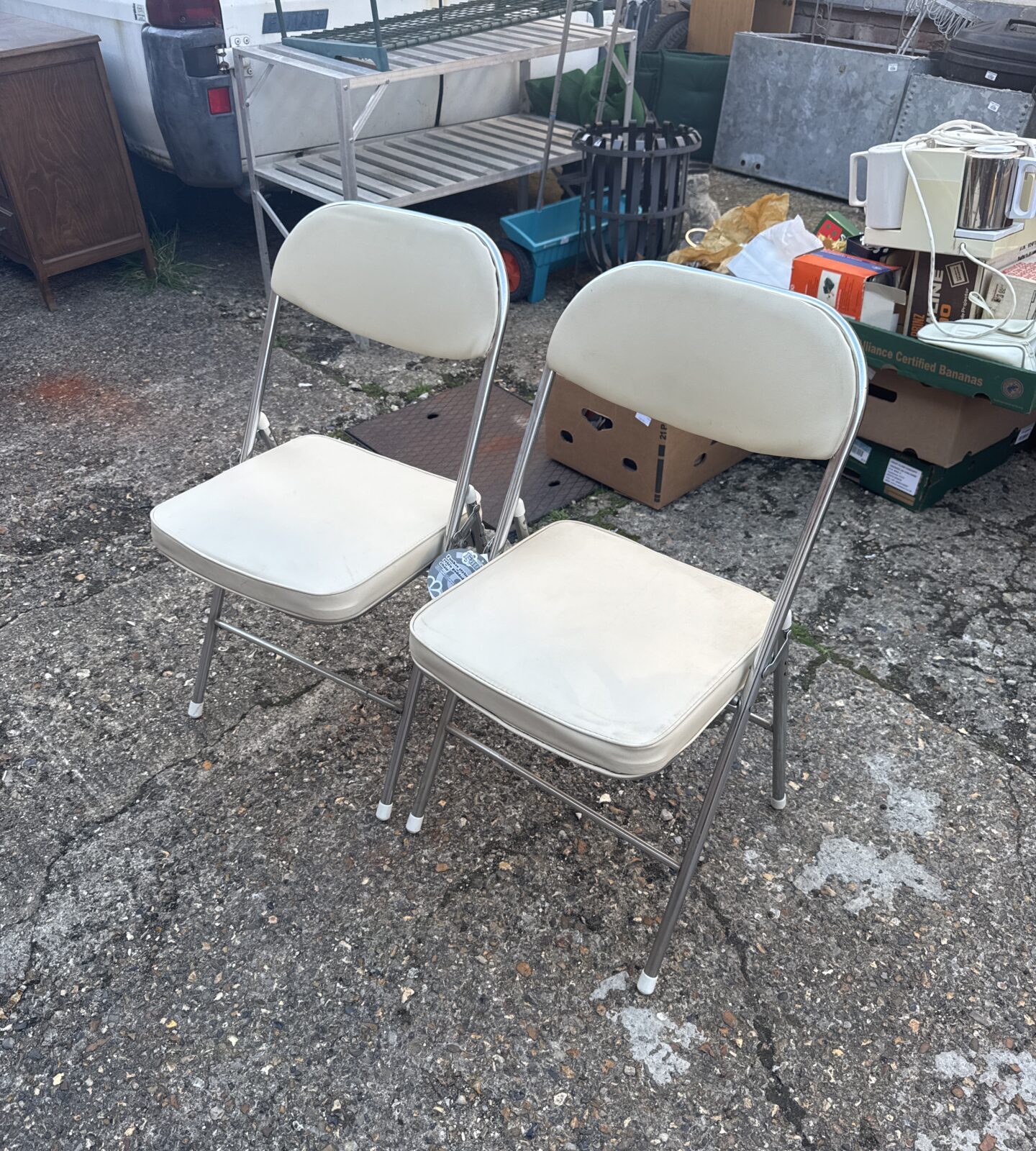 Pair of vintage retro folding chairs with padded seats.