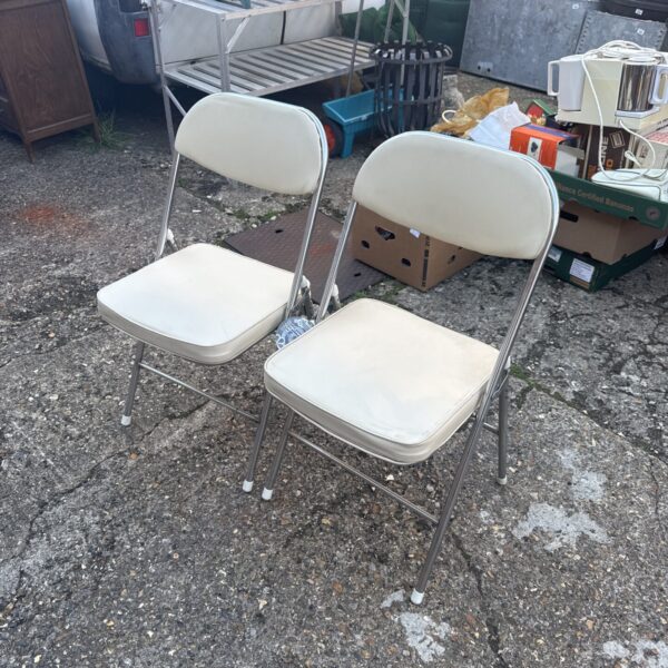 Pair of vintage retro folding chairs with padded seats.