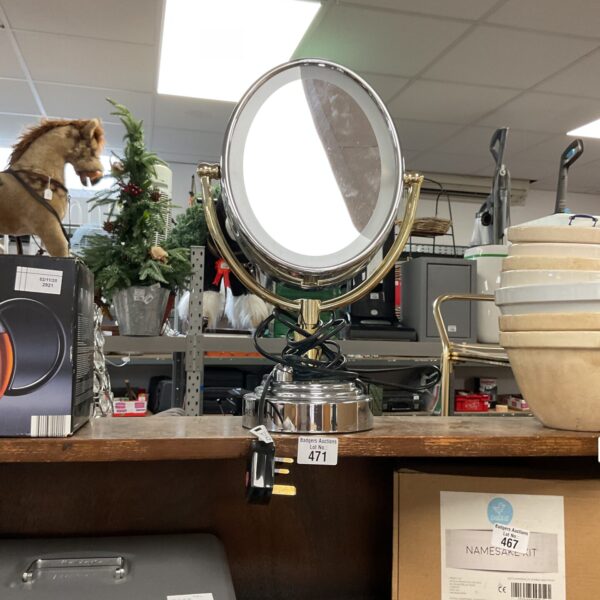 Vintage Revlon lighted vanity mirror for makeup application.