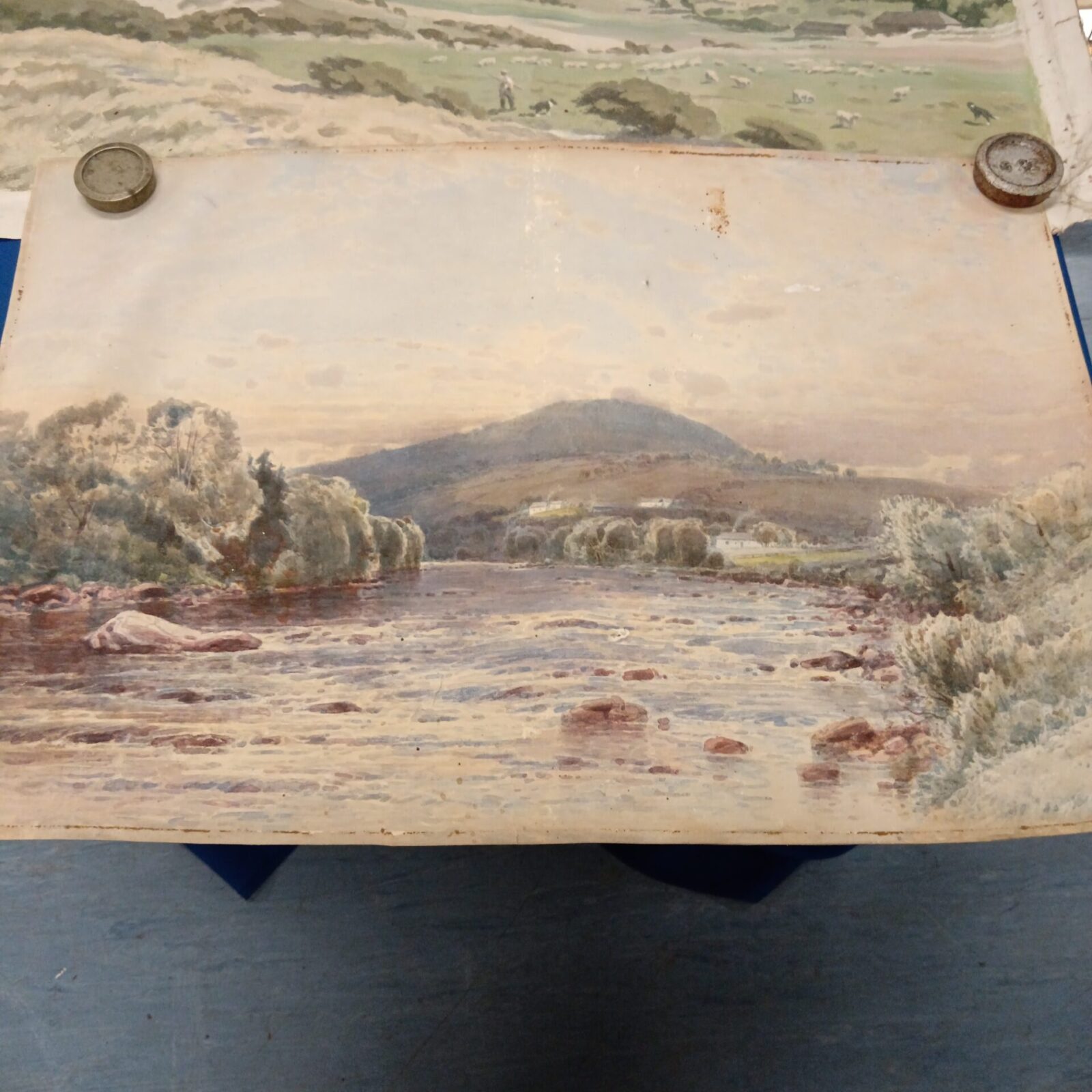 Watercolour painting of a river landscape with rolling hills.