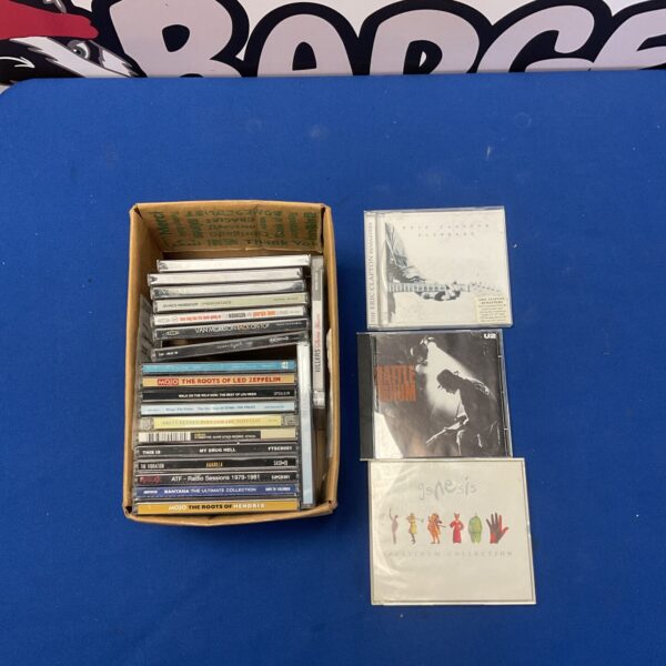 Lot of rock CDs including Genesis, Lou Reed, and Eric Clapton.