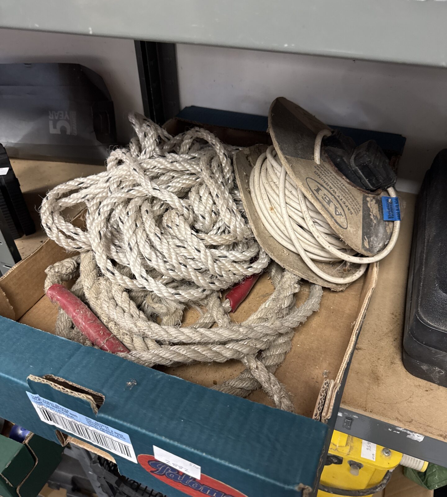 Close-up of a lot containing rope and an extension lead.