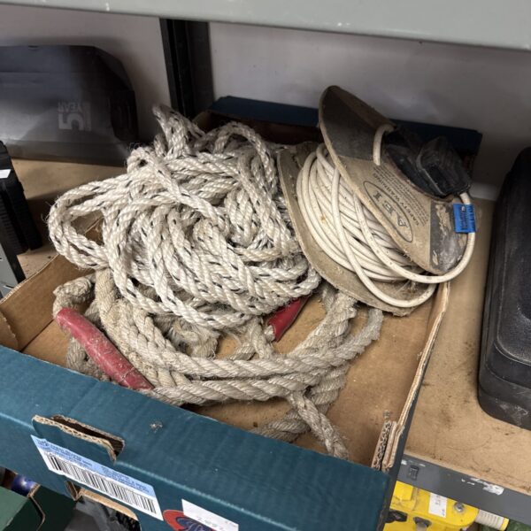 Close-up of a lot containing rope and an extension lead.