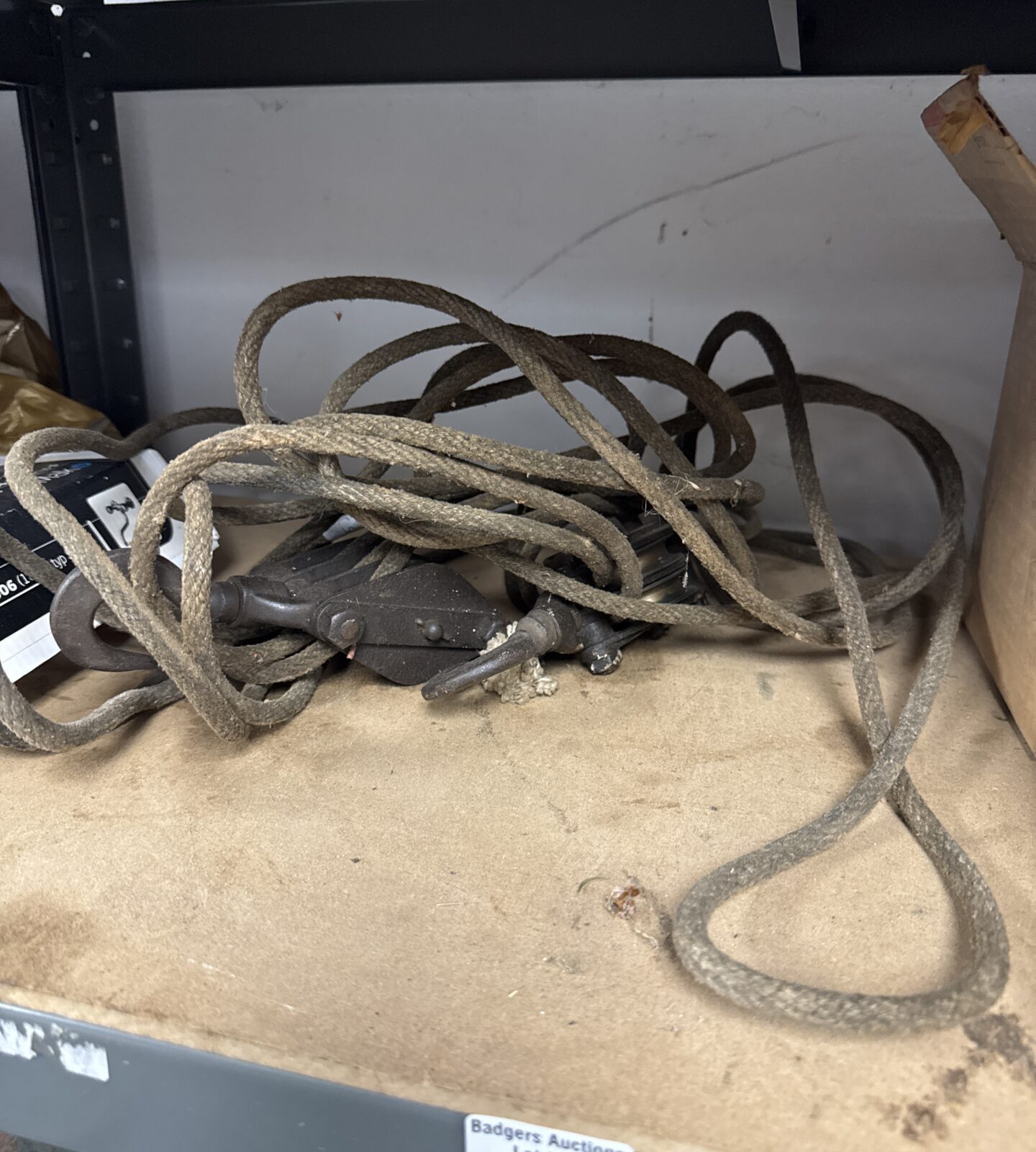 Vintage rope and pulley system with two small pulleys.