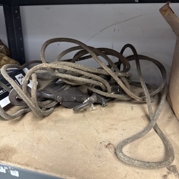 Vintage rope and pulley system with two small pulleys.