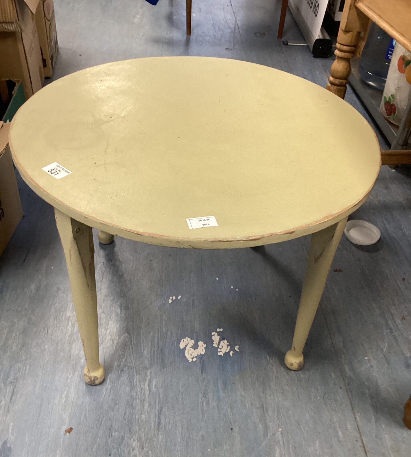 Vintage round wooden coffee table with curved legs.