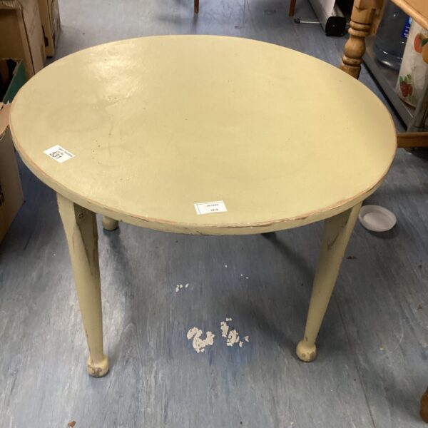 Vintage round wooden coffee table with curved legs.