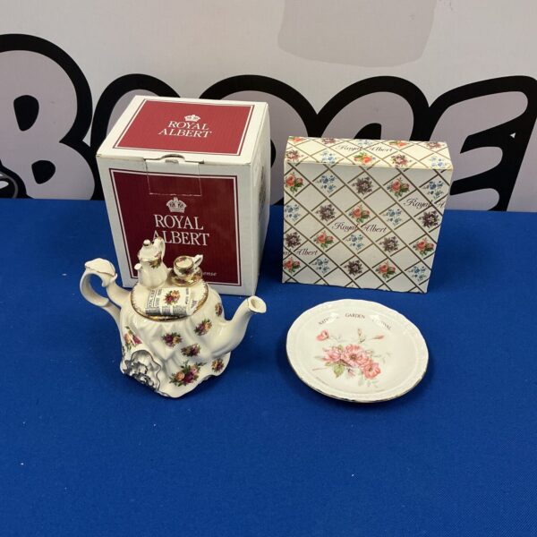 Vintage Royal Albert tea pot with delicate floral pattern.